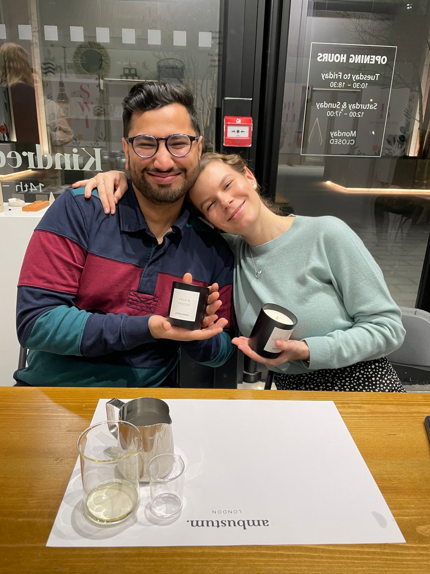 Two smiling people with their completed candles after an ambustum candle making workshop at battersea power station