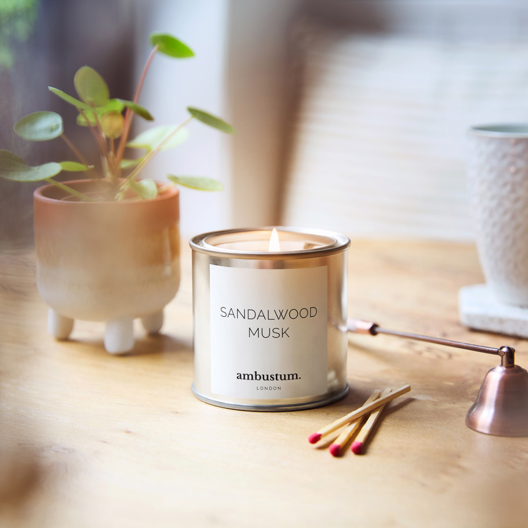 An ambustum Sandalwood Musk candle tin. Creamy and indulgent, with top notes of caramelised amber and honeyed sweet white musks. Our go to fragrance for a cosy evening, with warm patchouli and buttery Madagascan vanilla pods.